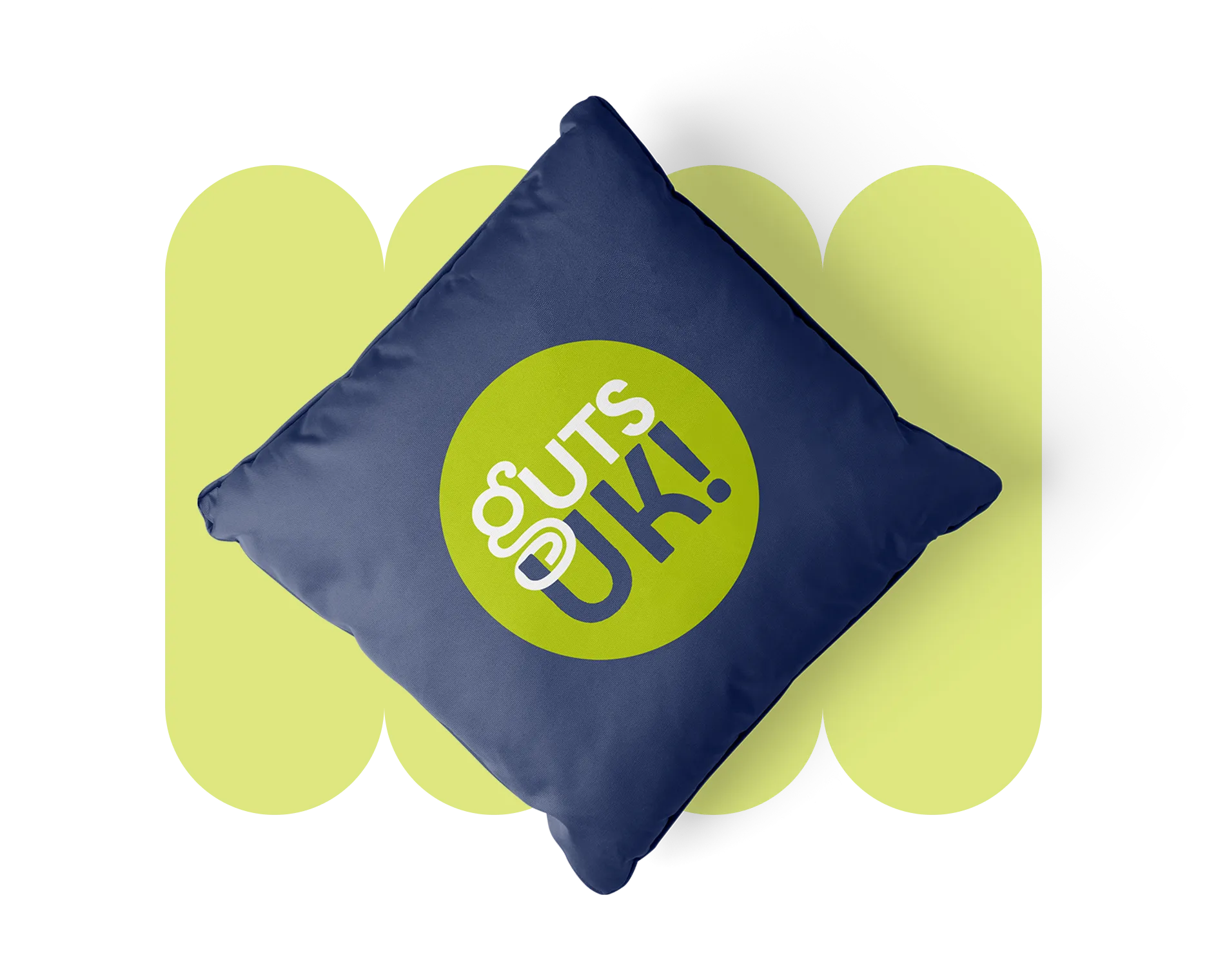 A navy cushion featuring the Guts UK logo, set against a pale green scalloped pattern